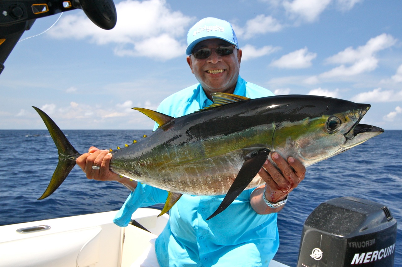 Man holding an already caught fish 