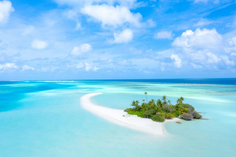 Maldives Island Under a Cloudy Blue Sky